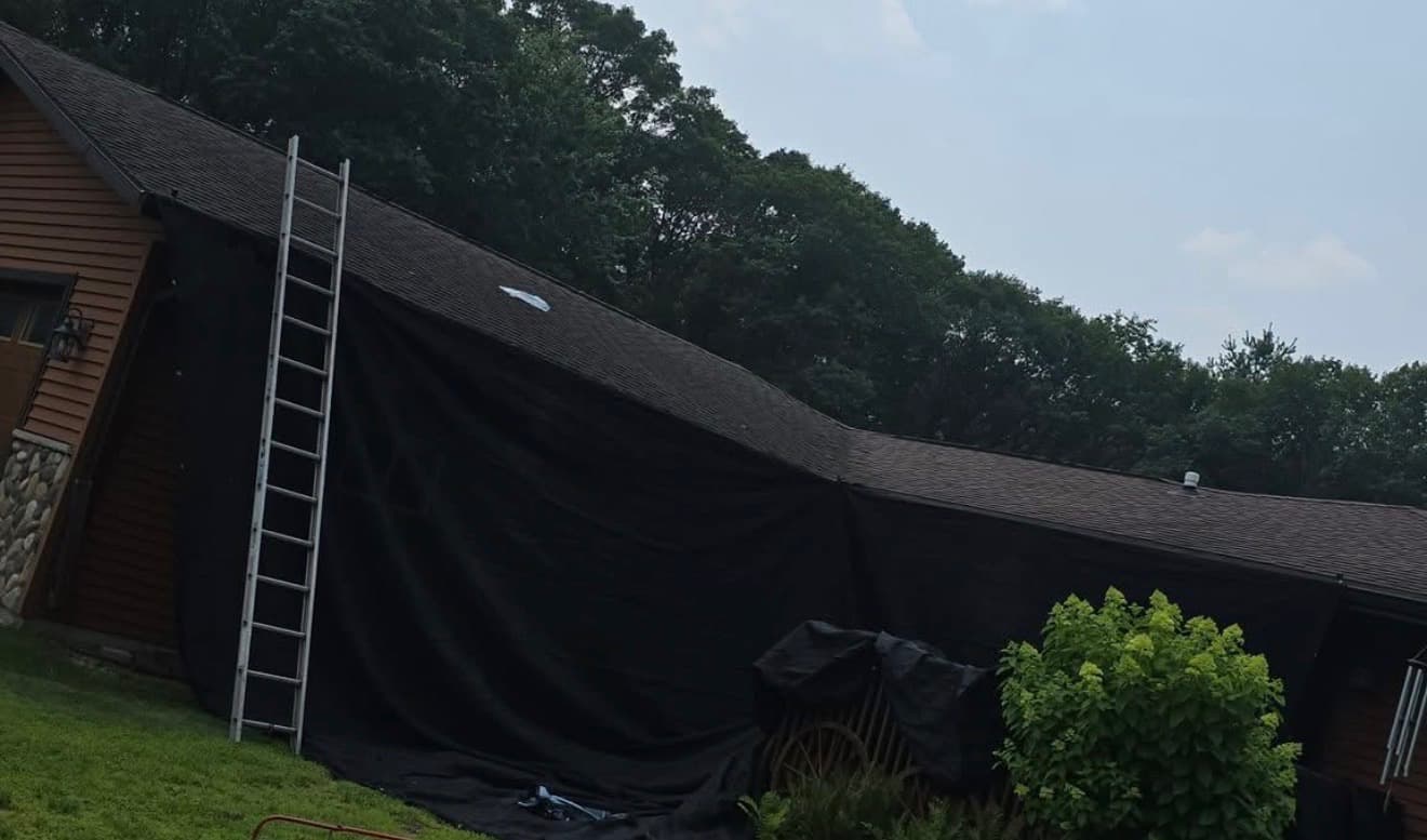 Large home covered for roofing work